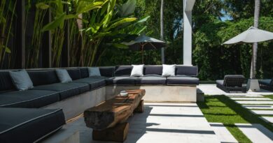 An outdoor living area with a couch, table and umbrellas